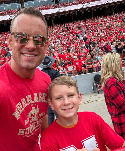 Thomas Raetz and son enjoying a football game after completing physical therapy in Omaha